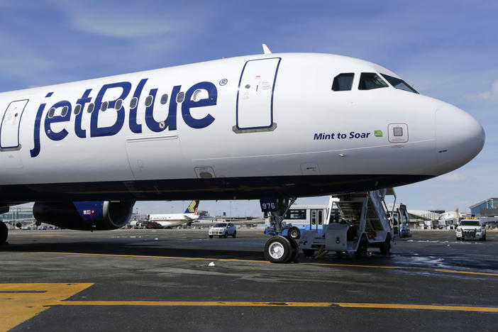 A JetBlue plane is shown at John F. Kennedy International Airport in New York on March 16, 2017. A federal judge has blocked JetBlue Airways from buying Spirit Airlines, saying the $3.8 billion deal would reduce competition.