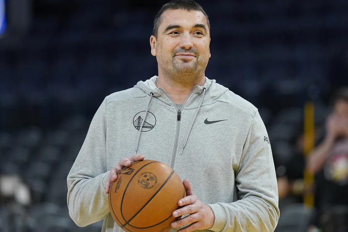 Golden State Warriors assistant coach Dejan Milojević smiles during an NBA preseason basketball game against the Denver Nuggets San Francisco, Friday, Oct. 14, 2022.