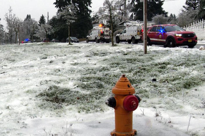 In this image made from a video provided by KGW, authorities work the scene Wednesday, Jan. 17, 2024, in Portland, Ore, after a power line fell on a vehicle, killing three people and injuring a baby during an ice storm that turned roads and mountain highways treacherous in the Pacific Northwest.