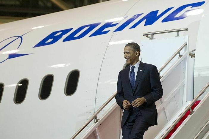 Then-President Barack Obama walks down the stairs of a Boeing 787 Dreamliner at the company's production facility in Everett, Wash., in 2012.