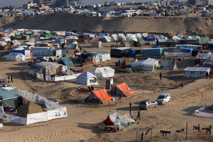 Displaced Palestinians take shelter in a makeshift tent camp by the beach in Rafah near the border with Egypt in the southern Gaza Strip on Tuesday, amid the ongoing conflict between Israel and the Palestinian militant group Hamas.