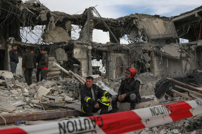 A civil defense team carries out search-and-rescue operations in a damaged building following a missile strike launched by Iran on Irbil, the capital of northern Iraq's Kurdish region, on Tuesday.