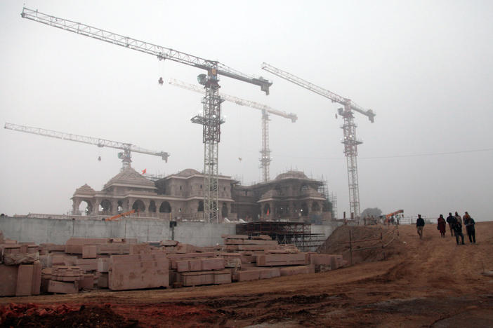 Building cranes tower over a new Hindu temple that will be consecrated with Indian Prime Minister Narendra Modi in attendance on Monday.