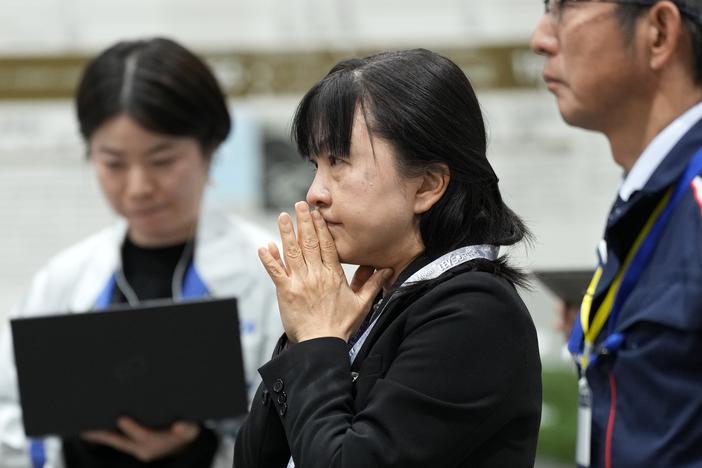 Staff of the Japan Aerospace Exploration Agency (JAXA) watch a live stream of the moon landing by the Smart Lander for Investigating Moon (SLIM) spacecraft at JAXA's Sagamihara Campus near Tokyo.