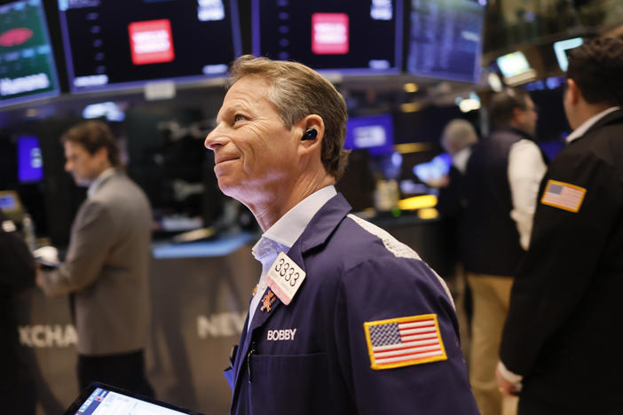 The S&P 500 hit a record high on Friday, boosted by gains in technology share and by rising hopes about the economy.