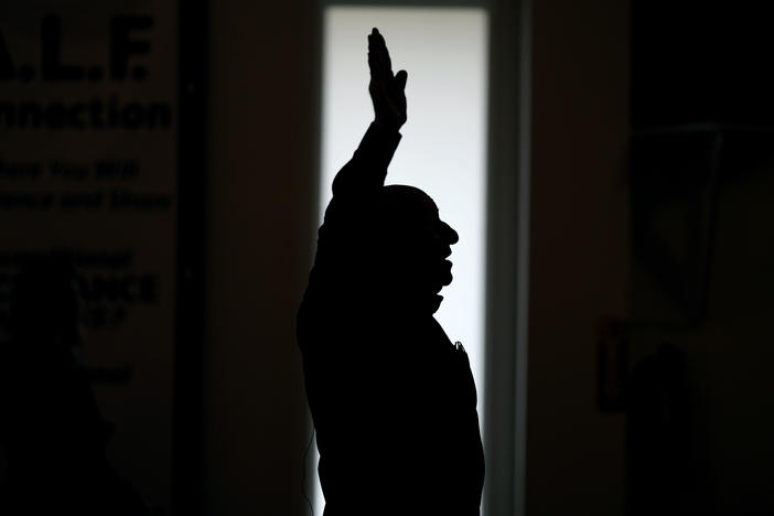 First Church of God Pastor Charles Hundley sings a hymn during the morning service, Sunday, Jan. 7, in Des Moines, Iowa. Former President Donald Trump and his rivals for the GOP nomination have pushed for endorsements from pastors and faith communities. Evangelicals and religious Christian groups are traditionally critical to the Republican Party.