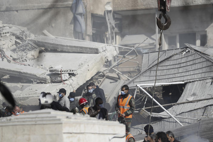 Emergency services work at a building hit by an air strike in Damascus, Syria, on Saturday.