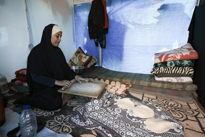 A displaced Palestinian woman prepares bread inside a tent at a makeshift camp in Rafah near the Gaza-Egypt border earlier this month.
