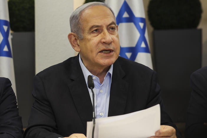 Israeli Prime Minister Benjamin Netanyahu, centre, speaks during the weekly cabinet meeting at the Defence Ministry in Tel Aviv, Israel, Sunday Jan. 7, 2024.