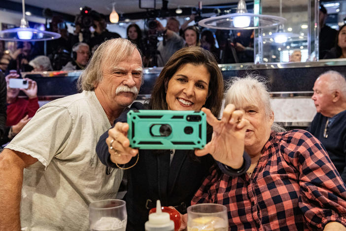 Former U.N. ambassador and 2024 Republican presidential hopeful Nikki Haley takes a selfie with voters at Mary Anne's Diner in Amherst, N.H.