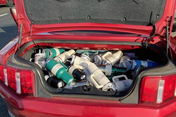 The department released photos from the traffic stop showing a trunk full of the cups.