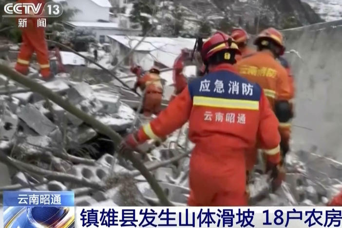 In this image taken from video footage run by China's CCTV, rescue workers search through rubbles in the aftermath of a landslide in liangshui village in southwestern China's Yunnan Province on Monday, Jan. 22, 2024.