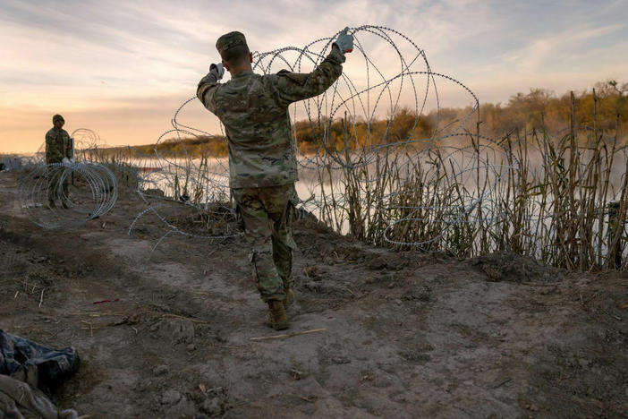 Texas National Guard soldiers install additional razor wire lie along the Rio Grande on Jan. 10 in Eagle Pass, Texas.