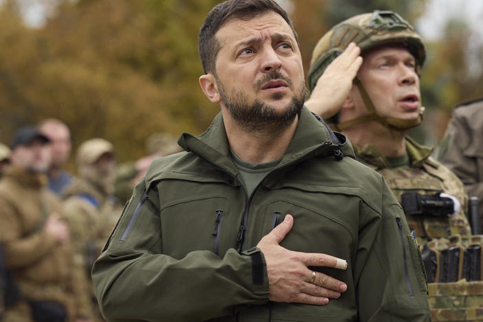 Ukrainian president Volodymyr Zelenskyy sings the national anthem during a visit to the city of Izium, in the Kharkiv, Sept. 14, 2022.