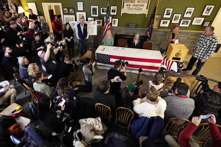 A large crowd of media and spectators watch as town moderator Tom Tillotson inserts Scott Maxwell's ballot shortly after midnight in the presidential primary election, Tuesday, Jan. 23, 2024, in Dixville Notch, N.H.