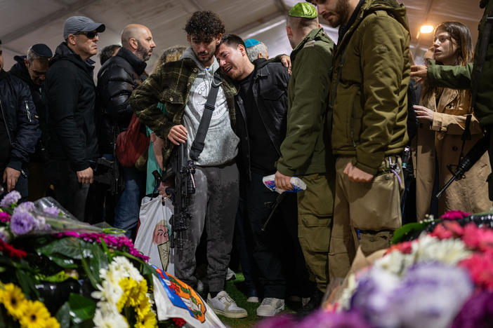 Family and friends of Israeli reservist Hadar Kapeluk, who was killed in combat in Gaza, mourn at his grave during his funeral at the Mount Herzl military cemetery in Jerusalem on Tuesday.