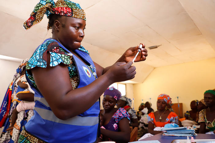 A nurse prepares to administer a newly approved malaria vaccine, RTS,S, to an infant at the health center in Datcheka, Cameroon, on Jan. 22. Cameroon is the first country in the vaccine campaign. Plans are to introduce the vaccine in 20 additional countries by 2025.
