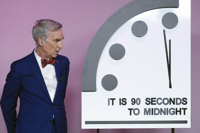 Science educator Bill Nye looks at the "Doomsday Clock," shortly before the Bulletin of the Atomic Scientists announces the latest decision on the "Doomsday Clock" minute hand, Tuesday, Jan. 23, 2024, at the National Press Club Broadcast Center, in Washington.