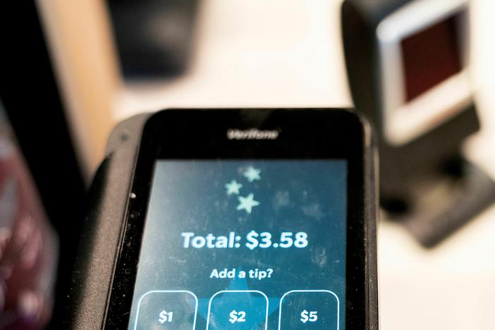 Tip options are displayed on a card reader at a store in Washington, D.C., on March 17, 2023.