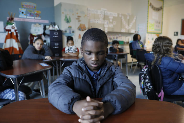A student named Royce closes his eyes during a mindfulness session in class at Patricia J. Sullivan Partnership School in Tampa, Fla. Students say the daily lessons help them cope with their feelings.