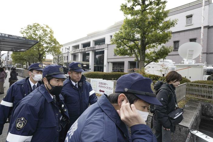 Police officers gather outside the Kyoto District Court in Kyoto, western Japan, Thursday, Jan. 25, 2024, ahead of the sentencing hearing for Shinji Aoba.