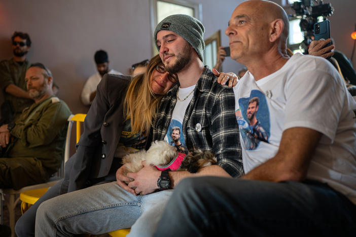 Idit (from left), Ronen and Kobi Ohel â mother, brother and father of Alon Ohel â listen to the concert.