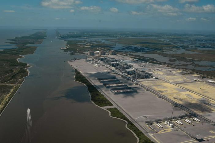 A boat sails down the Calcasieu Ship Channel past Cameron LNG, one of three liquified natural gas export plants in Cameron Parish, Louisiana.