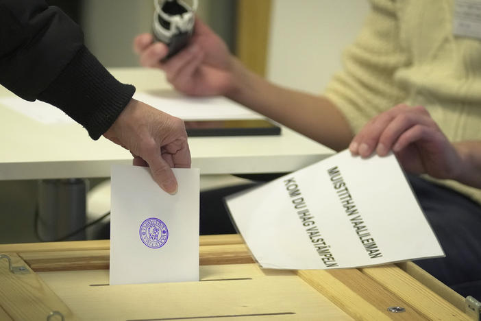 A woman casts her ballot at a polling station during presidential election in Helsinki, Finland, Sunday, Jan. 28, 2024.