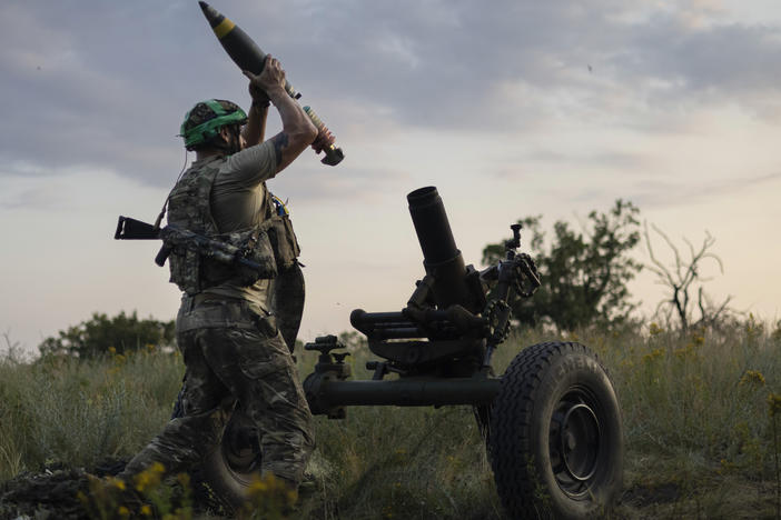 FILE - A Ukrainian serviceman of the 3rd Assault Brigade fires a 122mm mortar towards Russian positions at the front line, near Bakhmut, Donetsk region, Ukraine, Sunday, July 2, 2023. Employees from a Ukrainian arms firm conspired with defense ministry officials to embezzle almost $40 million earmarked to buy 100,000 mortar shells for the war with Russia, Ukraine's security service reported.