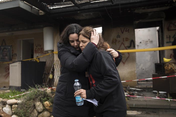 Amit Soussana (r), who was held hostage by Hamas and released hugs a friend near her house where she was kidnapped during the Oct. 7 attack on the kibbutz, on Jan. 29, 2024, in Kfar Aza, Israel. Many of the towns and kibbutzim attacked on that day remain completely evacuated, with their residents having relocated to other parts of Israel.