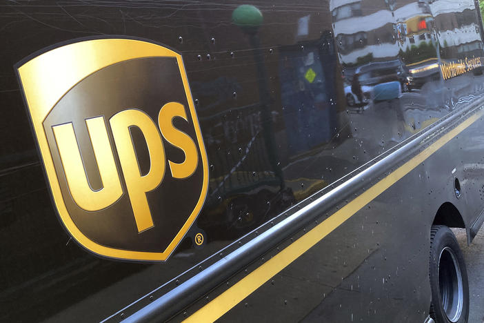 A UPS e truck is parked on a street in New York on May 11, 2023. On Tuesday, the company said it will cut 12,000 jobs.