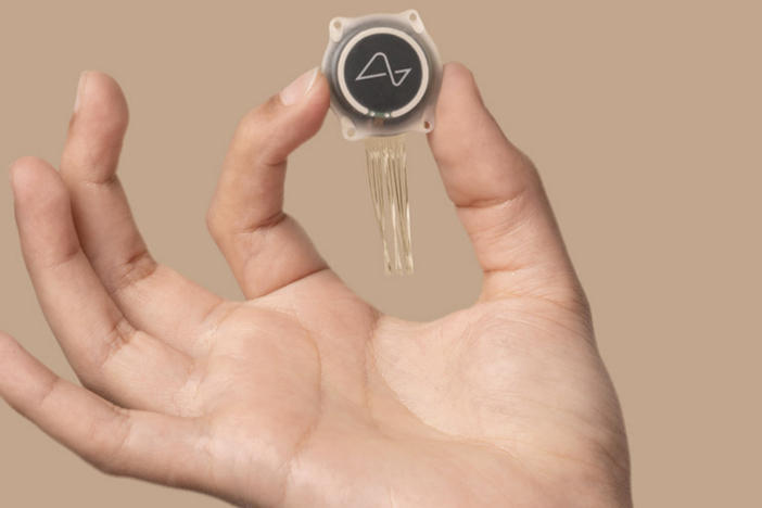 Neuralink has conducted its first surgical test of a brain implant, Elon Musk says. An example of the device, whose size has been compared to a coin and which has "threads" that connect to the brain, is seen here in a photo from the company's brochure.