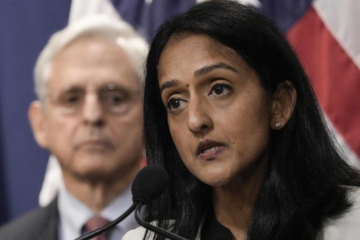 Associate Attorney General Vanita Gupta speaks during a news conference at the Justice Department on Aug. 2, 2022, as Attorney General Merrick Garland looks on.