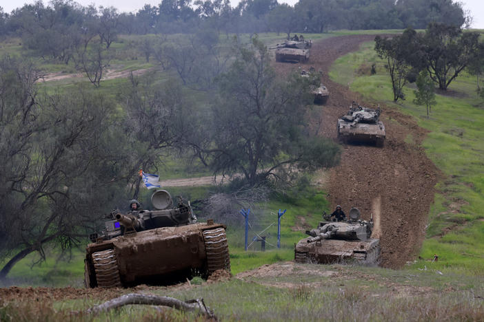 A unit of Israeli soldiers return with their tanks to the Israeli side of the border with the Gaza Strip on Sunday, after spending months in the Palestinian territory engaged.
