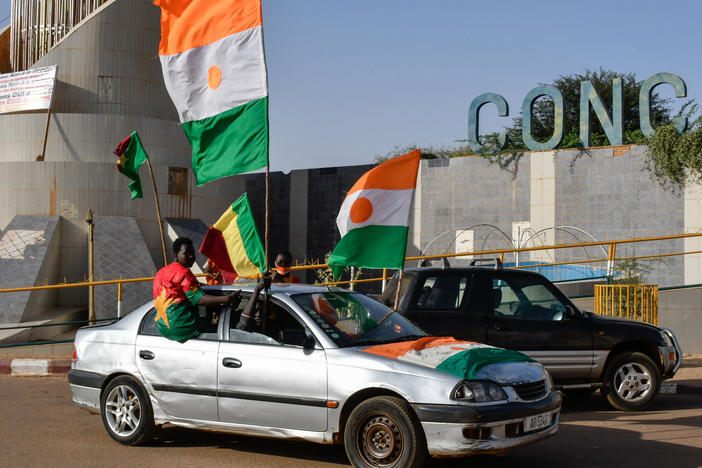 Supporters of the Alliance Of Sahel States (AES) drive with flags as they celebrate Mali, Burkina Faso and Niger leaving the Economic Community of West African States (ECOWAS) in Niamey on January 28, 2024.
