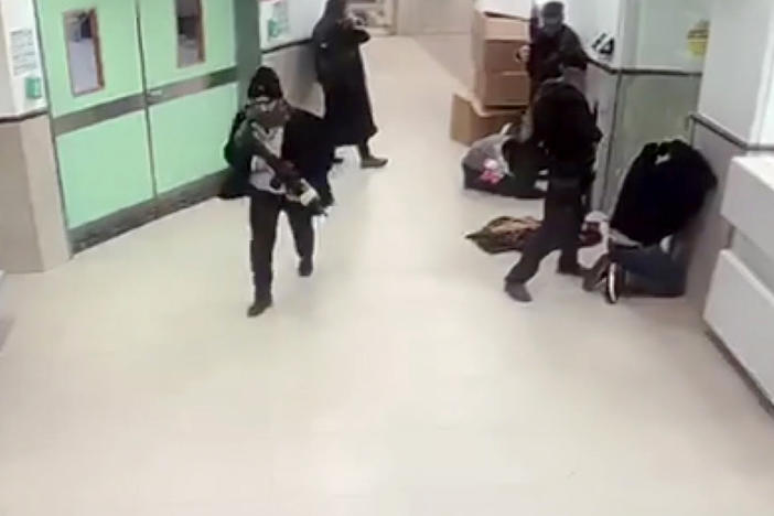 A screen grab from a security camera shows what hospital staff described as Israeli forces in disguise, holding weapons, raiding the Ibn Sina Hospital in Jenin, West Bank, on Tuesday,