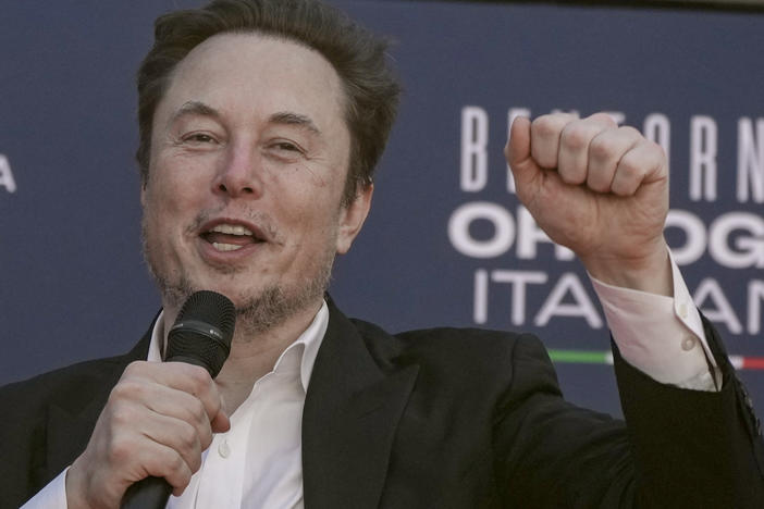 Tesla CEO Elon Musk waves as he arrives at the annual political festival Atreju, organized by the Giorgia Meloni's Brothers of Italy political party, in Rome, Dec. 16, 2023.