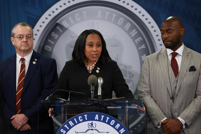 Fulton County District Attorney Fani Willis speaks in Atlanta on Aug. 14, 2023, after former President Donald Trump and his allies were indicted on state charges. At right is special prosecutor Nathan Wade. A personal relationship between Willis and Wade is at the center of misconduct claims against the DA's office.