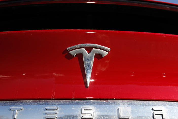 The Tesla company logo is shown in Littleton, Colo., in 2020. Tesla is recalling nearly all of the vehicles it has sold in the U.S. because some warning lights on the instrument panel are too small.
