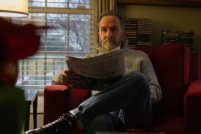 Writer George Pelecanos reads <em>The</em> <em>Washington Post</em> every morning in his home.