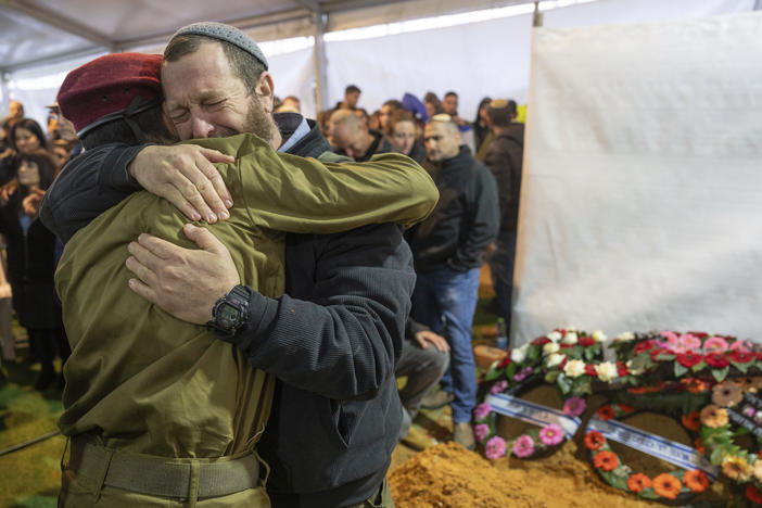 Mourners attend the funeral of reservist Gavriel Shani during his funeral at Mount Herzl military cemetery in Jerusalem on Wednesday, Jan. 31.