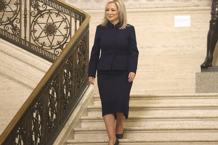 Sinn Fein Vice President Michelle O'Neill walks down steps at Stormont Parliament Buildings in Belfast, Northern Ireland, on Saturday. O'Neill made history by becoming the first Irish nationalist leader of Northern Ireland.