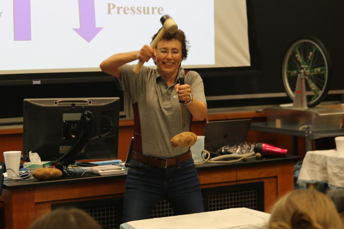 During a Summer Science Safari demonstration at Texas A&M University in 2022, Dr. Tatiana hits a knife down to make the potato go up. It's not magic, it's inertia.