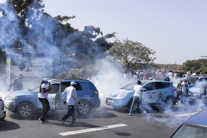 Senegalese riot police lob tear gas at supporters of opposition presidential candidate Daouda Ndiaye, in Dakar, Senegal, on Sunday.