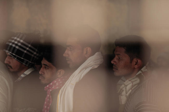 Indian men line up at a registration office set up in a technical college in the northern Indian city of Lucknow, where they hope to sign up to work in Israel.