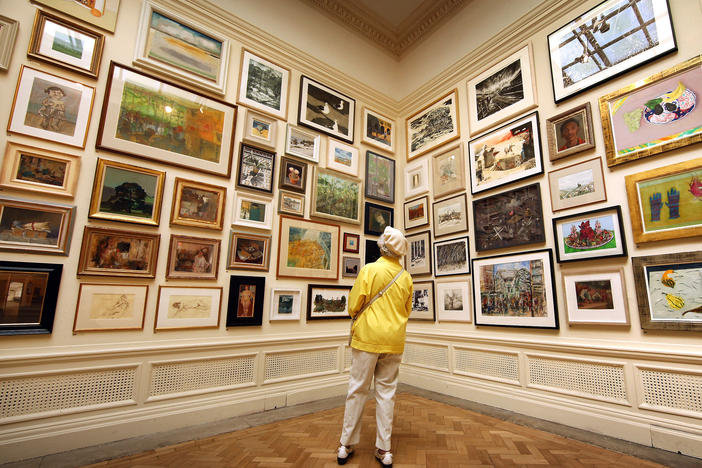In her new book <em>Get the Picture, </em>journalist Bianca Bosker explores why connecting with art sometimes feels harder than it has to be. Above, a visitor takes in paintings at The Royal Academy Summer Exhibition in London in 2010.