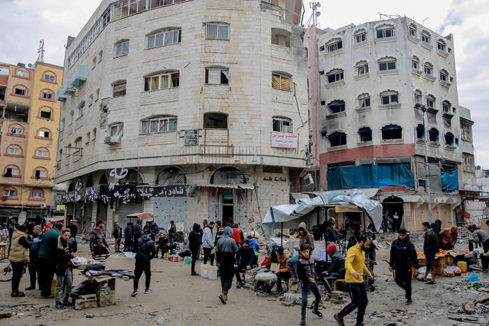 On a January day, people explore the streets of Gaza City, where researchers estimate 72% or more of buildings have been damaged or destroyed.
