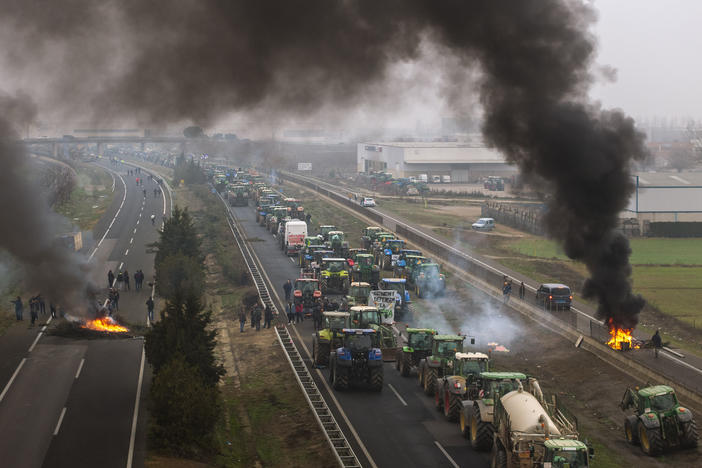 Farmers make barricades after blocking a highway during a protest near Mollerussa, northeast Spain, Tuesday, Feb. 6, 2024.