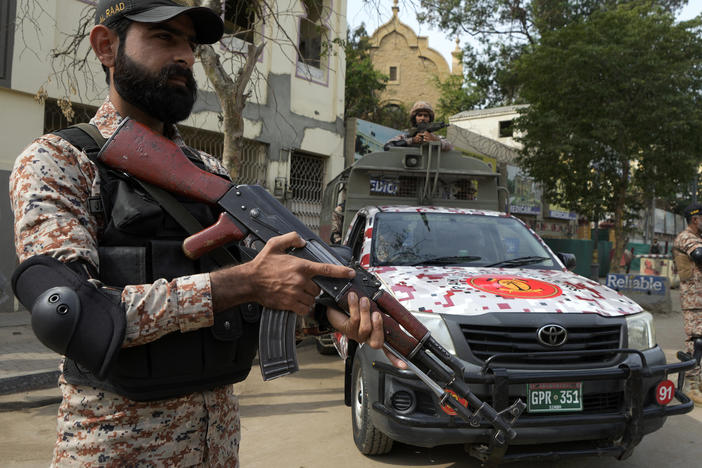 Paramilitary soldiers stand guard on the side of a road for security, ahead of Feb. 8 general elections, in Karachi, Pakistan, Wednesday, Feb. 7, 2024.