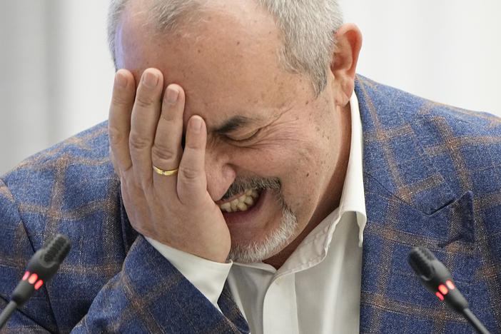 Boris Nadezhdin, a liberal Russian politician who is seeking to run in the March 17 presidential election, laughs during a meeting of the Russia's Central Election Commission in Moscow, Thursday.